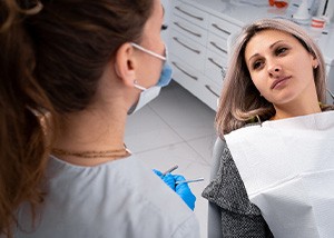 Brenham patient talking about dental implant side-effects with dentist
