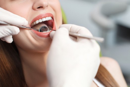 Nose-to-shoulder view of woman undergoing dental exam