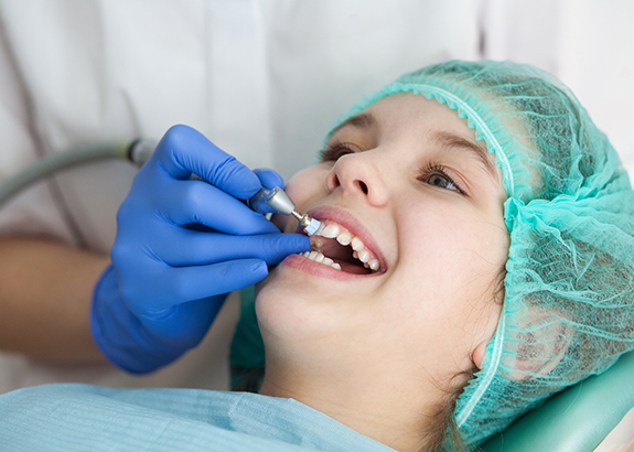 Child receiving a professional teeth cleaning