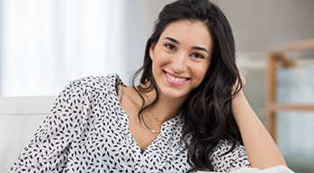 Smiling woman with long wavy dark hair