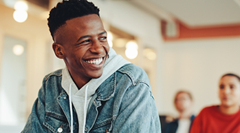 Smiling young man in a denim jacket